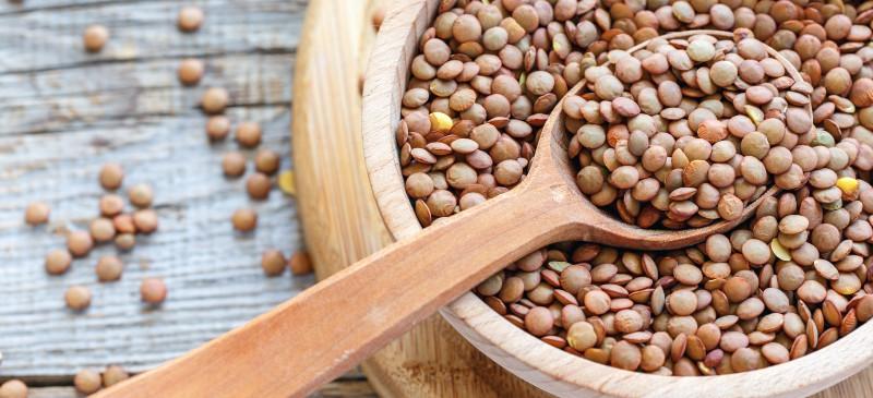 Lentil millets in a with a wooden spoon