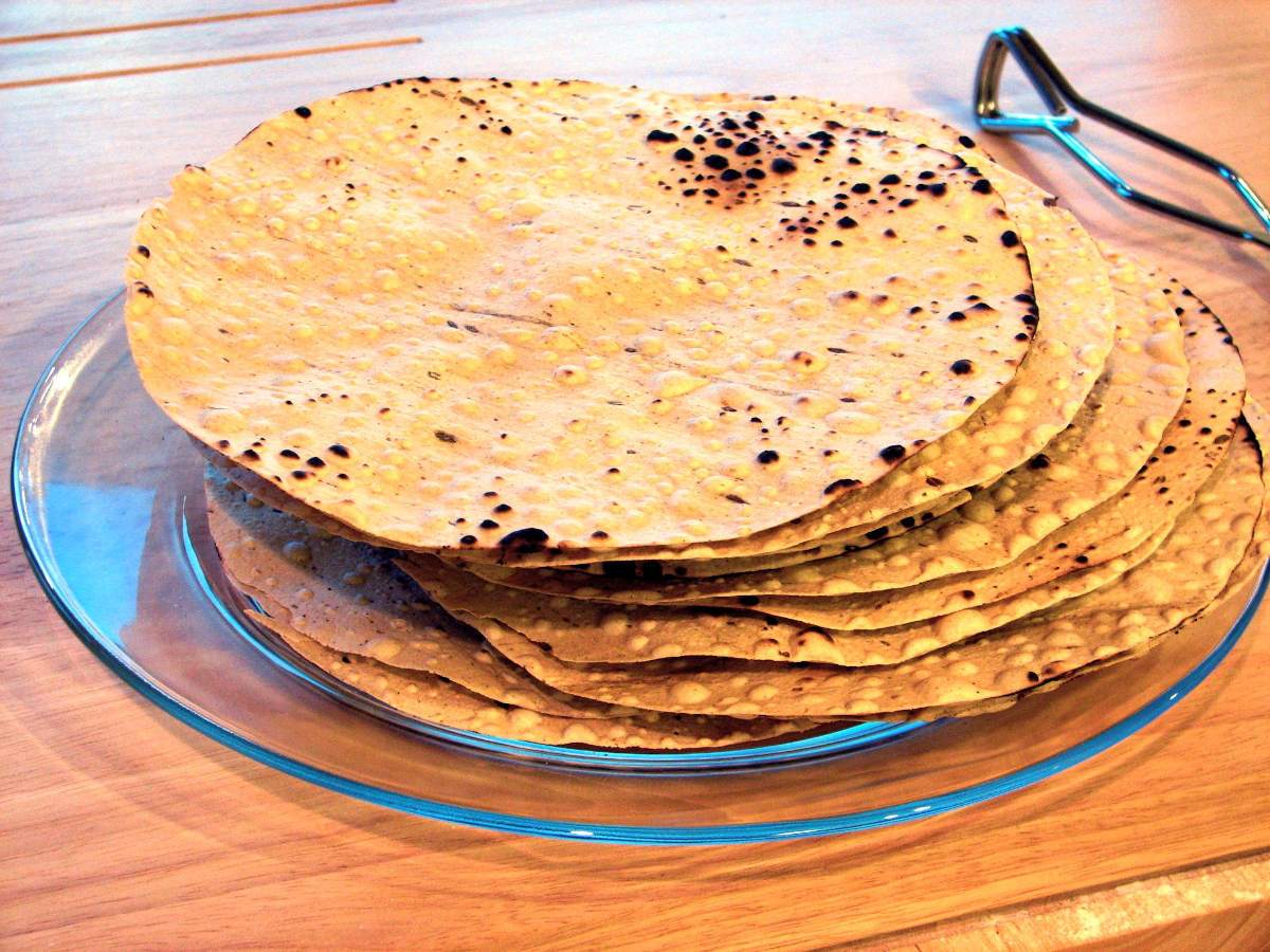 Stack of dried papadums in a glass plate