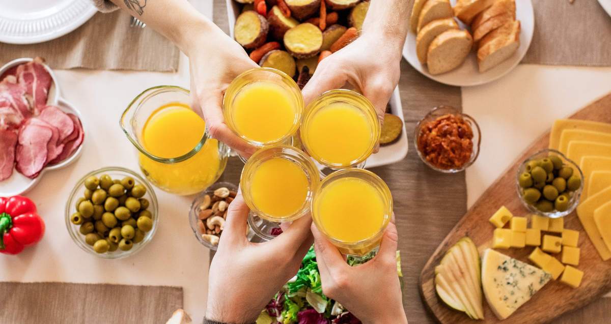 Friends making a toast with a glass of juice