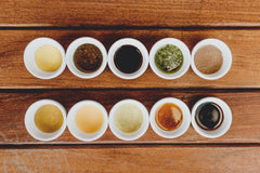 Set of different condiments each placed on a saucer