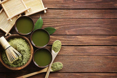 Green matcha powder and green matcha tea in a wooden surface