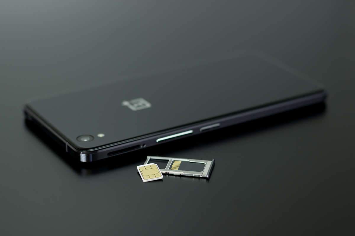 Close up of sim card and black phone